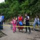 Locals look at the place where the current of a river swept away several houses at Dios es Fiel shantytown, an annex of the Kjell Laugerud colony in Guatemla City. Photo Credit: AFP