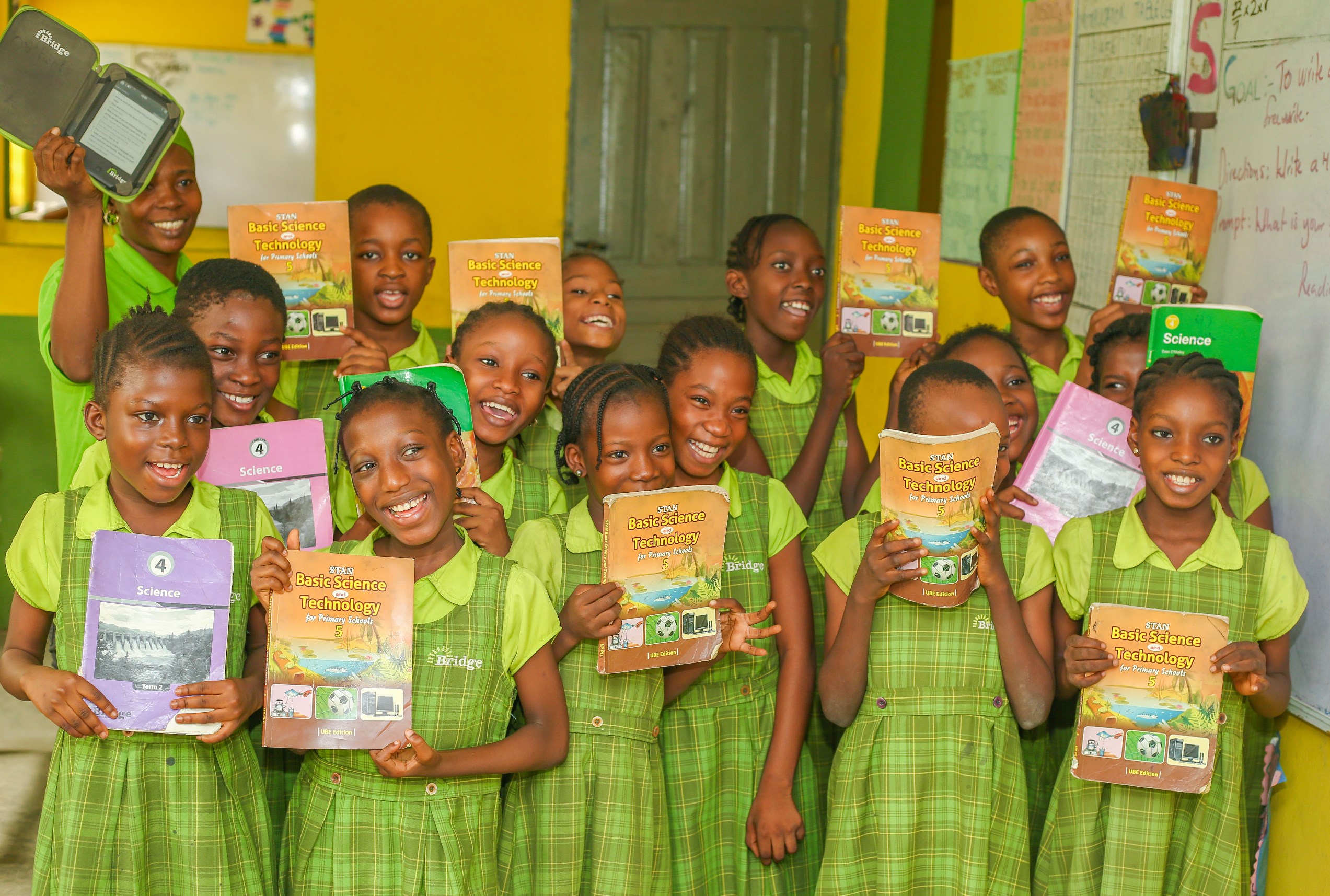 Photo caption: Girls at a Bridge school showing their science textbooks