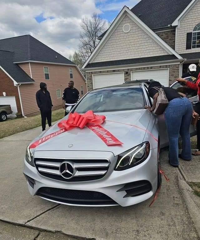 (PHOTOS) US-based Nigerian nurse gifts her husband who brought her to America Mercedes Benz on 50th birthday.