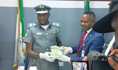 Applauds as Customs hand over seized foreign currency to EFCC