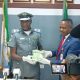 Applauds as Customs hand over seized foreign currency to EFCC