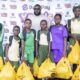 Femi Hanson (middle), Head of Marketing & Communications with some of the beneficiaries of the initiative redeeming their shopping vouchers